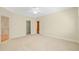 Bedroom with neutral carpeting, a ceiling fan and three doors at 4831 Crestmore Rd # 202, Raleigh, NC 27612