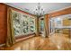 Dining area with hardwood floors, large windows and decorative chandelier at 4831 Crestmore Rd # 202, Raleigh, NC 27612