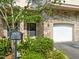 Charming townhome with stone accents, a garage, and well-maintained landscaping at 4831 Crestmore Rd # 202, Raleigh, NC 27612