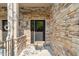 Close up of entrance door #202 with stone exterior and black door at 4831 Crestmore Rd # 202, Raleigh, NC 27612