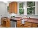 Bright kitchen featuring stainless steel appliances, custom cabinets and a sink with two windows at 4831 Crestmore Rd # 202, Raleigh, NC 27612