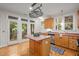 Charming kitchen with an island, stainless steel appliances, and an exterior door leading to a balcony at 4831 Crestmore Rd # 202, Raleigh, NC 27612