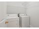 Laundry room featuring a white washer and dryer with overhead shelving at 4831 Crestmore Rd # 202, Raleigh, NC 27612