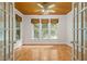 Spacious living room featuring french doors, hardwood flooring, and three windows at 4831 Crestmore Rd # 202, Raleigh, NC 27612