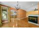 Open-concept living room featuring hardwood floors, fireplace and a decorative chandelier at 4831 Crestmore Rd # 202, Raleigh, NC 27612