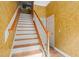 Bright stairway with white trim and hardwood stairs and flooring at 4831 Crestmore Rd # 202, Raleigh, NC 27612