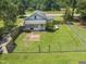Aerial view of home with fenced in backyard, grassy lawn, and patio area at 4880 Old Us Hwy 64, Zebulon, NC 27597