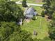 Aerial view of the home showing fenced yard, mature trees, and an outdoor brick patio at 4880 Old Us Hwy 64, Zebulon, NC 27597