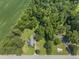 Wide aerial view showing property, surrounding forest, and proximity to neighborhood at 4880 Old Us Hwy 64, Zebulon, NC 27597