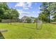 Large fenced yard with beautiful green grass, mature trees and a partial view of the house at 4880 Old Us Hwy 64, Zebulon, NC 27597