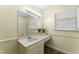 Bathroom featuring a vanity with sink, an ornate light fixture, and a window for natural light at 4880 Old Us Hwy 64, Zebulon, NC 27597
