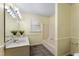 Bathroom featuring a vanity with sink, shower/tub with curtain, and a window for natural light at 4880 Old Us Hwy 64, Zebulon, NC 27597