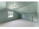 Bedroom with light-green walls, white trim, window, neutral carpet, and sloped ceiling at 4880 Old Us Hwy 64, Zebulon, NC 27597