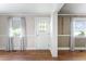 Bright entryway with a wood-look floor, front door with sheer curtain, and two large windows at 4880 Old Us Hwy 64, Zebulon, NC 27597