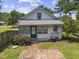 Exterior aerial view featuring brick patio, front door, and mature landscaping at 4880 Old Us Hwy 64, Zebulon, NC 27597
