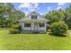 Charming one-and-one-half story home featuring a cozy front porch and lush green lawn at 4880 Old Us Hwy 64, Zebulon, NC 27597