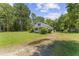 Home exterior with a partial view of the lawn, mature trees, and driveway at 4880 Old Us Hwy 64, Zebulon, NC 27597