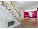 Foyer with staircase and view into dining area featuring a striking magenta accent wall at 4880 Old Us Hwy 64, Zebulon, NC 27597