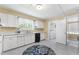 Functional kitchen featuring bright cabinetry, and a view to the laundry area at 4880 Old Us Hwy 64, Zebulon, NC 27597