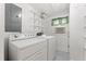 Bright laundry room equipped with washer, dryer, shelving, and window AC unit at 4880 Old Us Hwy 64, Zebulon, NC 27597