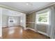 View of bright living room with light walls, wood-look flooring, and large windows with sheer curtains at 4880 Old Us Hwy 64, Zebulon, NC 27597
