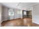View of living room with an entry door, and windows with sheer curtains, and wood-look flooring at 4880 Old Us Hwy 64, Zebulon, NC 27597