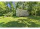 Backyard shot of weathered wooden outbuilding surrounded by shade trees at 4880 Old Us Hwy 64, Zebulon, NC 27597