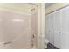 Shower and toilet in a bathroom with neutral walls and wood-look floors and closet at 4880 Old Us Hwy 64, Zebulon, NC 27597