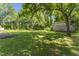 Mature trees, outbuilding, and green grass in a large backyard at 4880 Old Us Hwy 64, Zebulon, NC 27597