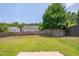 View of spacious backyard featuring a wood fence and mature tree at 5000 Mocha Ln, Raleigh, NC 27616