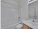Bathroom with shower-tub combo, white tile and sink at 5000 Mocha Ln, Raleigh, NC 27616