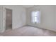 Bedroom featuring a window, neutral carpet, and ensuite bathroom at 5000 Mocha Ln, Raleigh, NC 27616