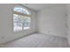 Bright bedroom featuring a large window, neutral carpet, and fresh paint at 5000 Mocha Ln, Raleigh, NC 27616