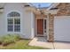 Close-up of the front door, framed by a picture window and stone accents at 5000 Mocha Ln, Raleigh, NC 27616