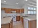 Bright kitchen with white appliances, center island, and light wood cabinets at 5000 Mocha Ln, Raleigh, NC 27616