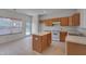 Bright kitchen features a center island, neutral countertops, and wood cabinets at 5000 Mocha Ln, Raleigh, NC 27616
