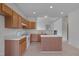 Bright kitchen with white appliances, center island, and light wood cabinets at 5000 Mocha Ln, Raleigh, NC 27616