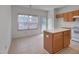 Bright kitchen with white appliances, center island, and a view of the breakfast nook at 5000 Mocha Ln, Raleigh, NC 27616