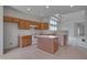 Bright kitchen with white appliances, center island, and light wood cabinets at 5000 Mocha Ln, Raleigh, NC 27616