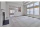 Spacious living room with large windows, fireplace, and coffered ceiling at 5000 Mocha Ln, Raleigh, NC 27616