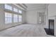 Bright living room features many windows, neutral carpet, and fireplace at 5000 Mocha Ln, Raleigh, NC 27616