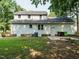 Backyard features mature trees, lawn, a fence and multiple access doors at 505 Commander Dr, Wendell, NC 27591