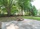 Spacious backyard featuring mature trees, lawn and concrete patio at 505 Commander Dr, Wendell, NC 27591