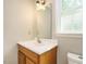 Bathroom vanity featuring a window, wood cabinets, and a large mirror at 505 Commander Dr, Wendell, NC 27591