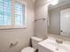 Bathroom with a modern toilet, sink, and a window with plantation shutters at 505 Commander Dr, Wendell, NC 27591