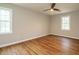 Bedroom with hardwood floors, ceiling fan, and natural light from the windows at 505 Commander Dr, Wendell, NC 27591