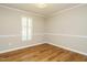 Cozy bedroom with natural light filtering through shuttered windows and wood-style flooring at 505 Commander Dr, Wendell, NC 27591