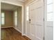 Bright foyer featuring a white front door with sidelights and hardwood-style floors at 505 Commander Dr, Wendell, NC 27591