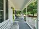 Inviting covered front porch with classic white railing and a cozy seating area at 505 Commander Dr, Wendell, NC 27591