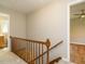 Hallway and staircase with carpet leading to rooms featuring hardwood floors at 505 Commander Dr, Wendell, NC 27591